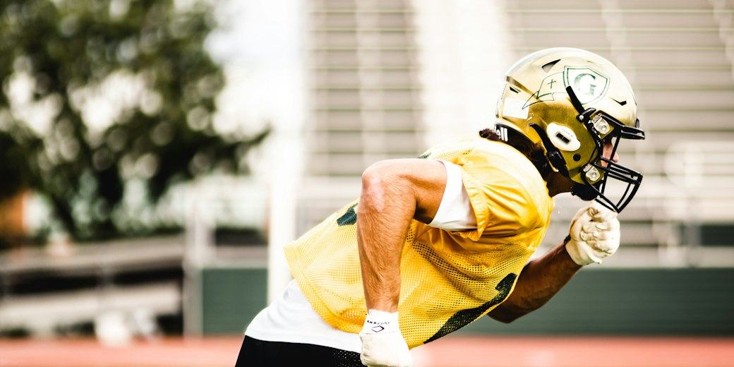 Football player running a route on the field